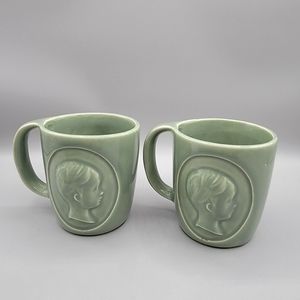 Pair of Mccoy pottery Rho Gam Ortho Pharmaceutical Child Silhouette 3D Mugs VGT